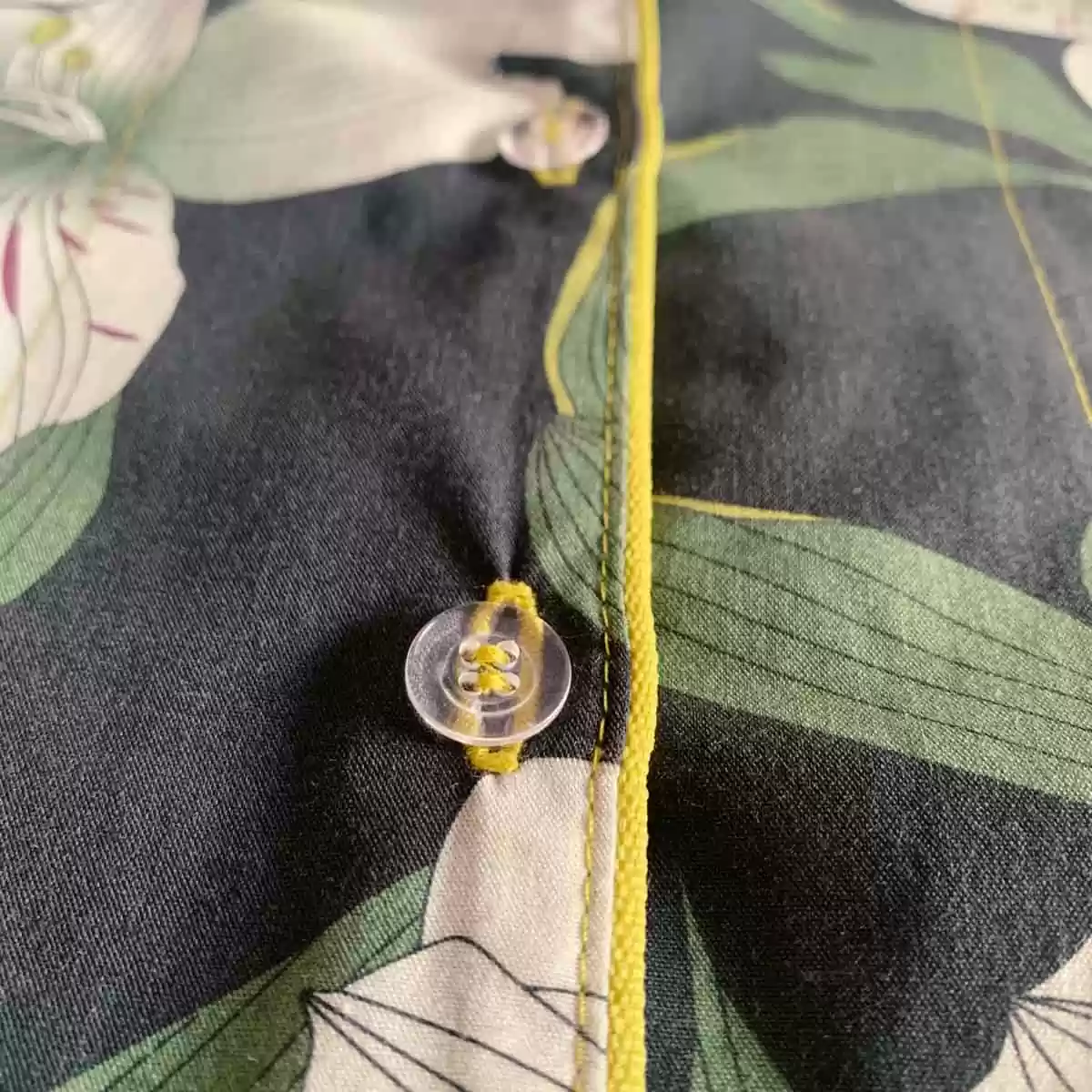 Detalhe de acabamento e botões do pijama Naps na estampa Encanto Noturno